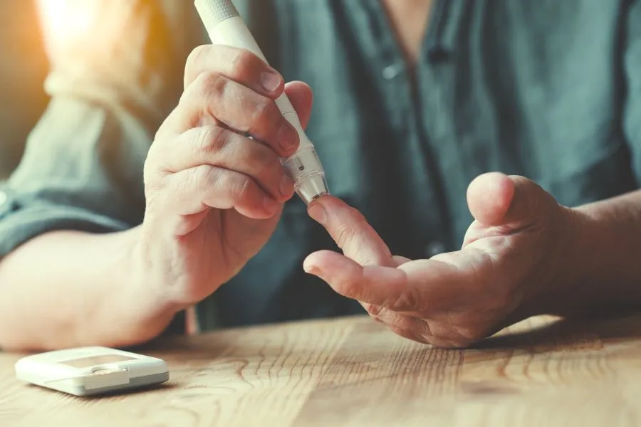 person checking blood sugar with blood test